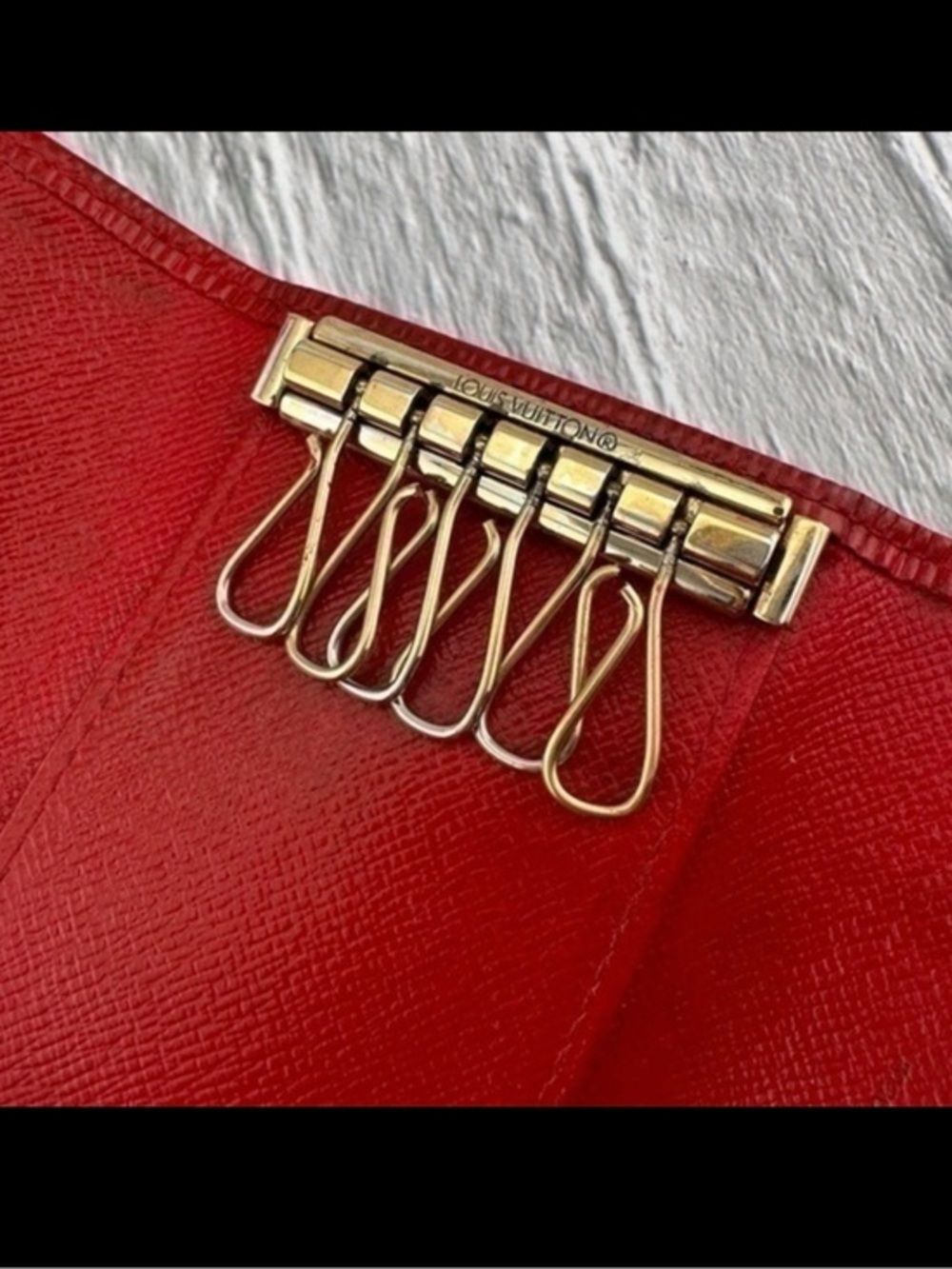 AUTHENTIC Louis Vuitton key holder. Previously owned. Color: Castilian red.